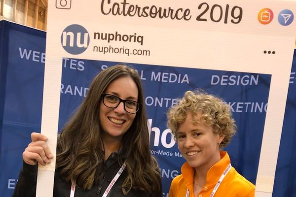 Erin *& Jamie holding the instagram sign at the nuphoriq booth