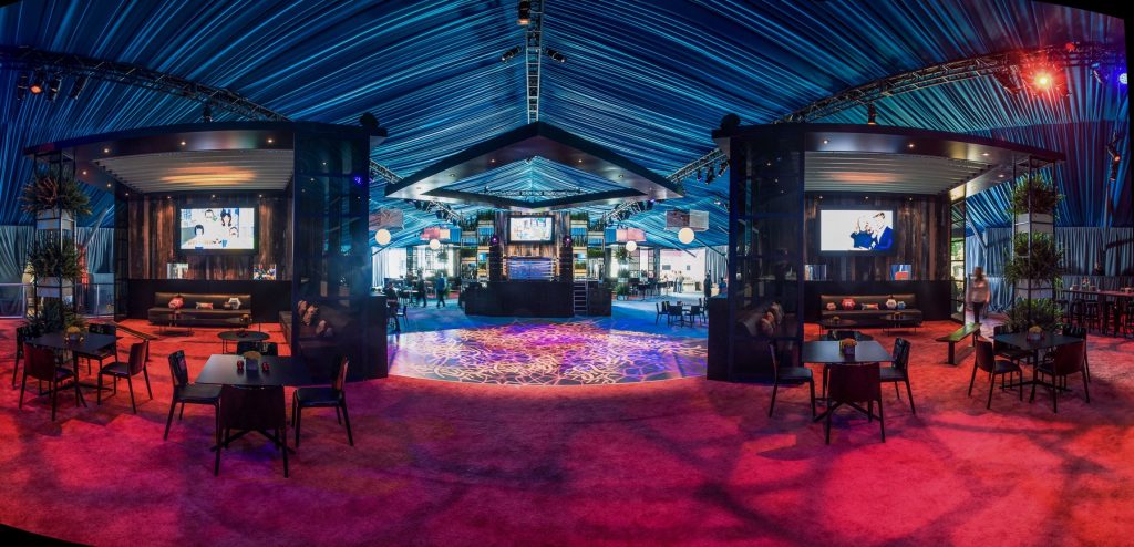 Large indoor catered event with red lighting