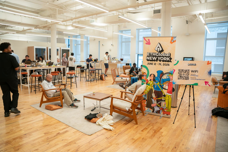 People work and relax in a bright, modern co-working space with an ETHGlobal New York event sign in the foreground.