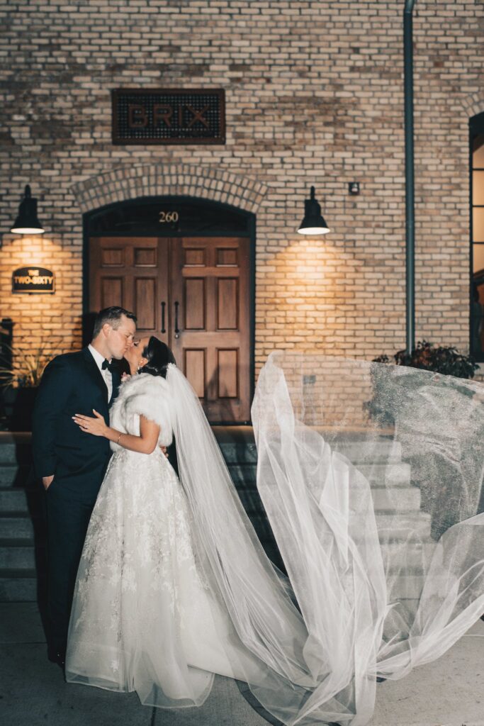 wedding couple kissing outside
