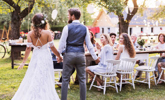 Backyard wedding with bride and groom and guests