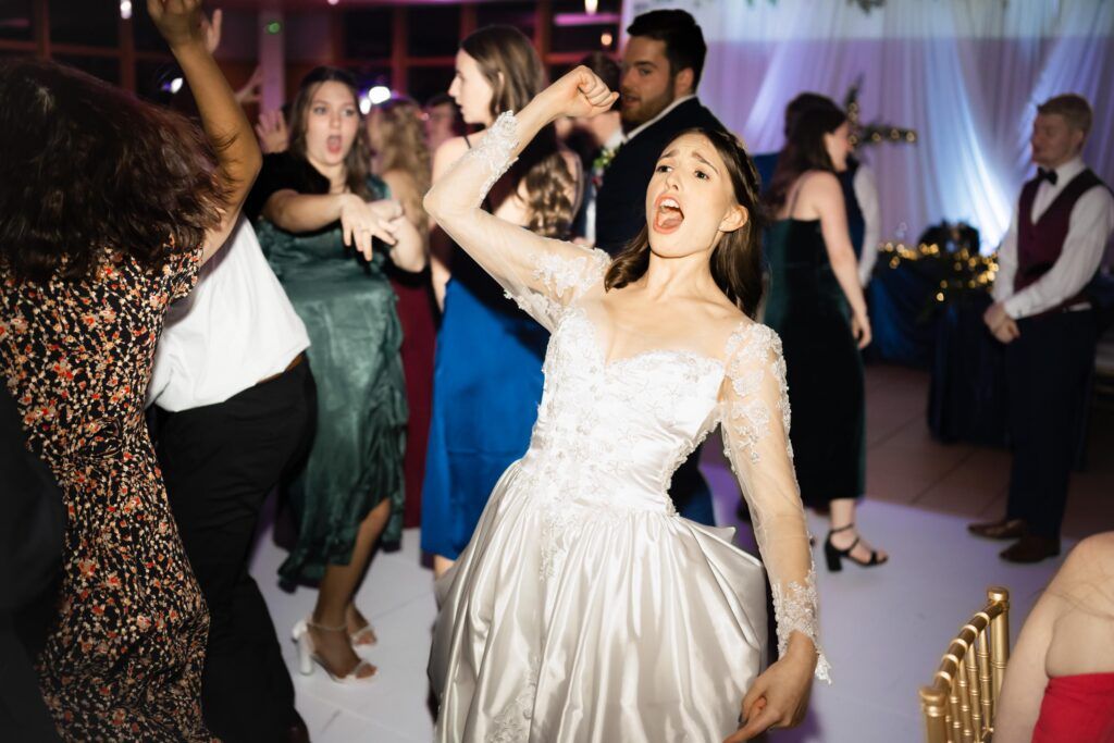 Bride cheering and dancing.