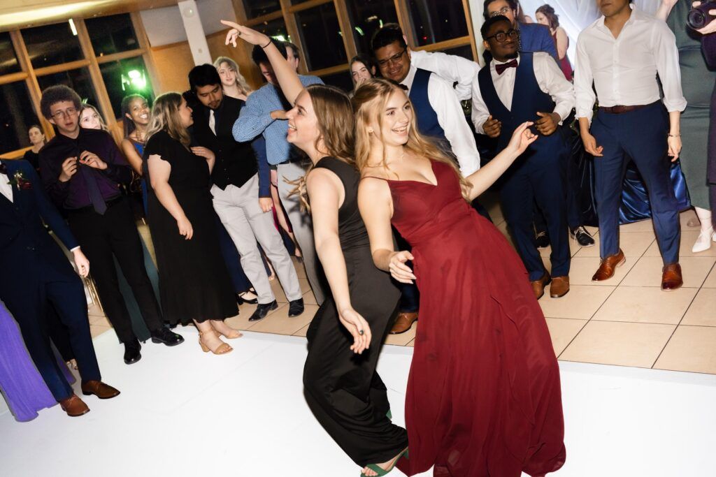 Bridesmaid and guests dancing.