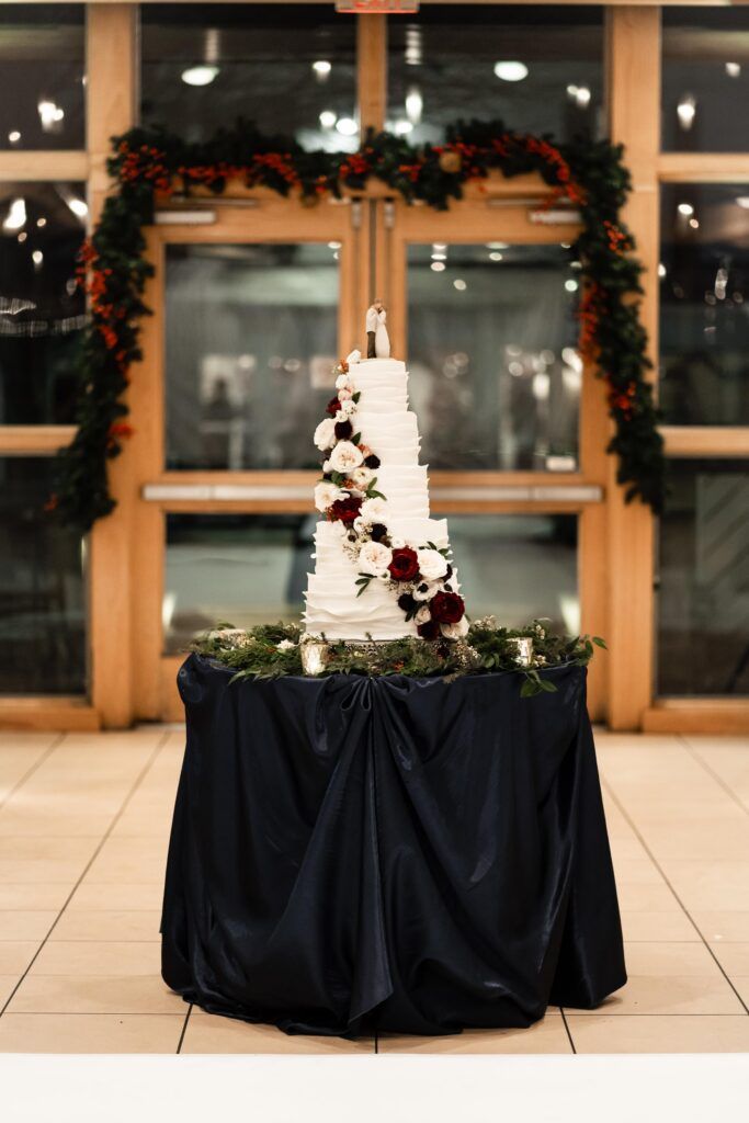 Tiered wedding cake with flowers spiraling down.