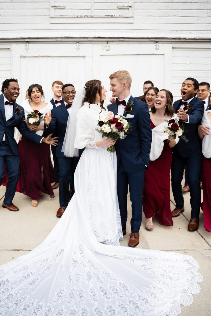 Newlyweds and bridal party outside.