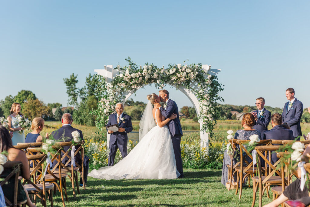 wedding couple kissing at altar