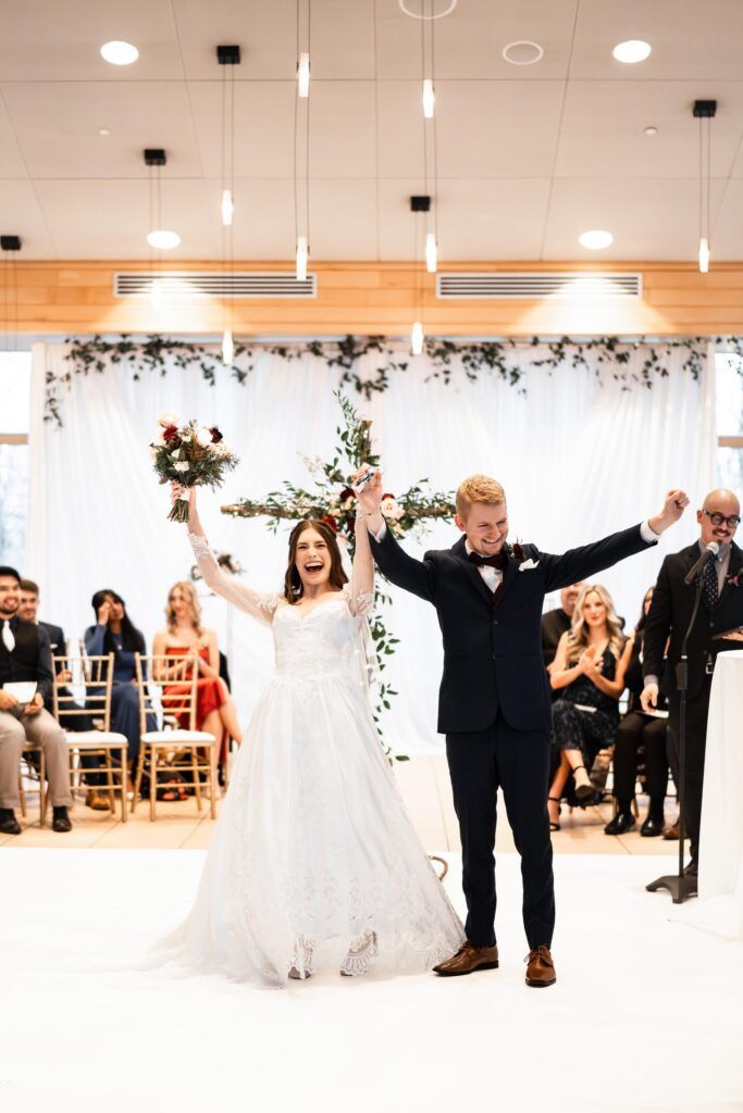 Newlyweds walking up the aisle.