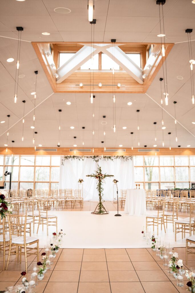 Ceremony with chairs and floral cross.