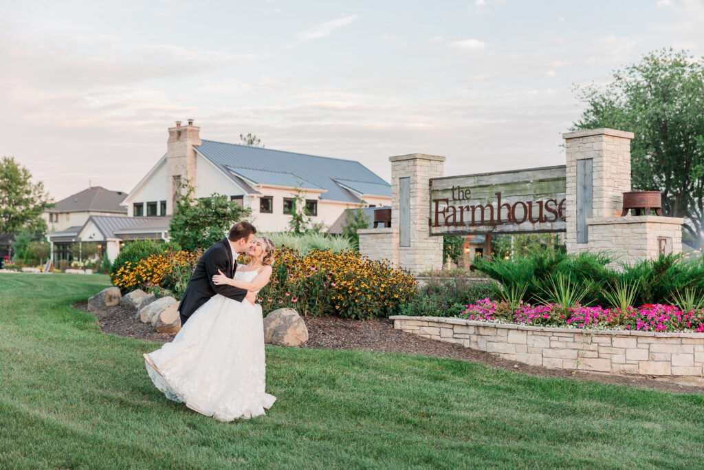 bride and groom kissing outside
