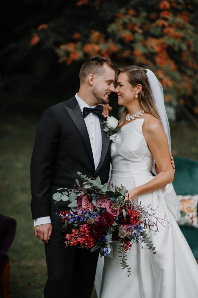 Newlyweds embrace, looking into each others eyes.