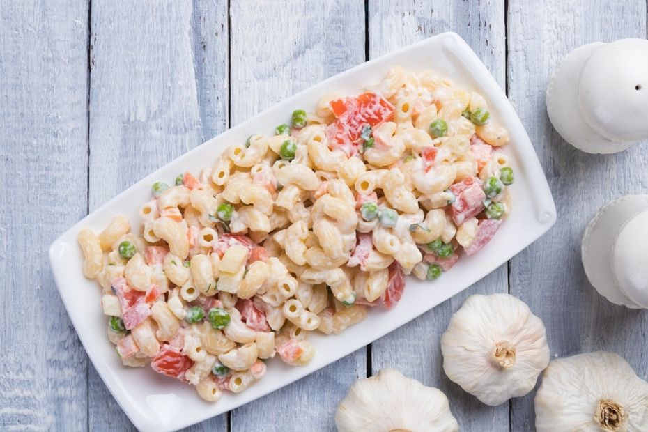 Macaroni salad on a white rectangular serving platter