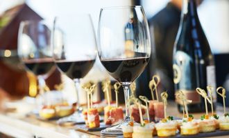 Wine glasses and small appetizers on a counter