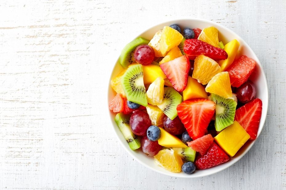 Bowl of fresh fruit on a lite gray background