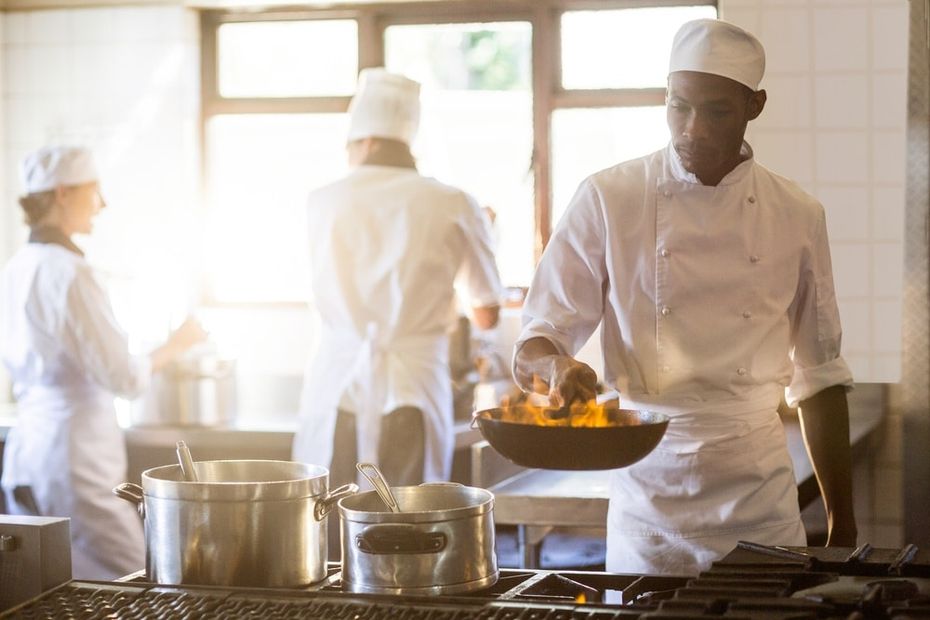 Chefs in stainless steel commercial kitchen