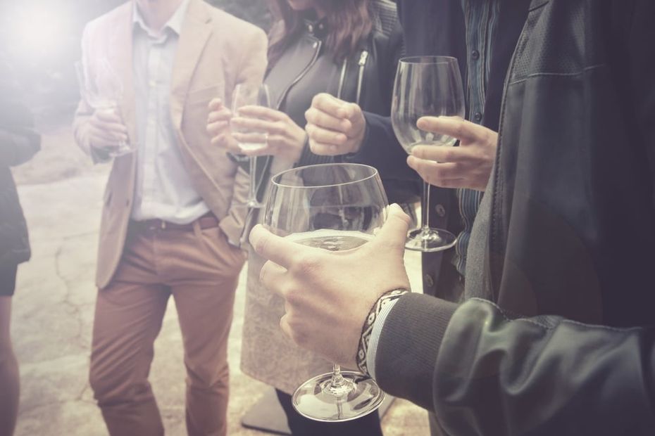 Business people standing around with cocktail glasses in their hands