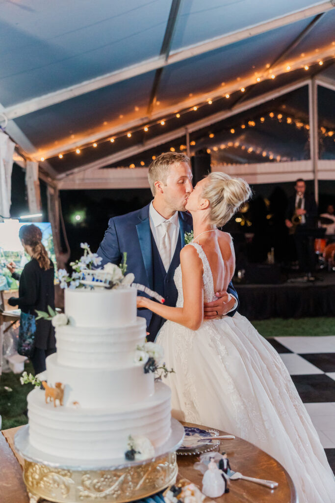 bride and groom kissing and cutting cake