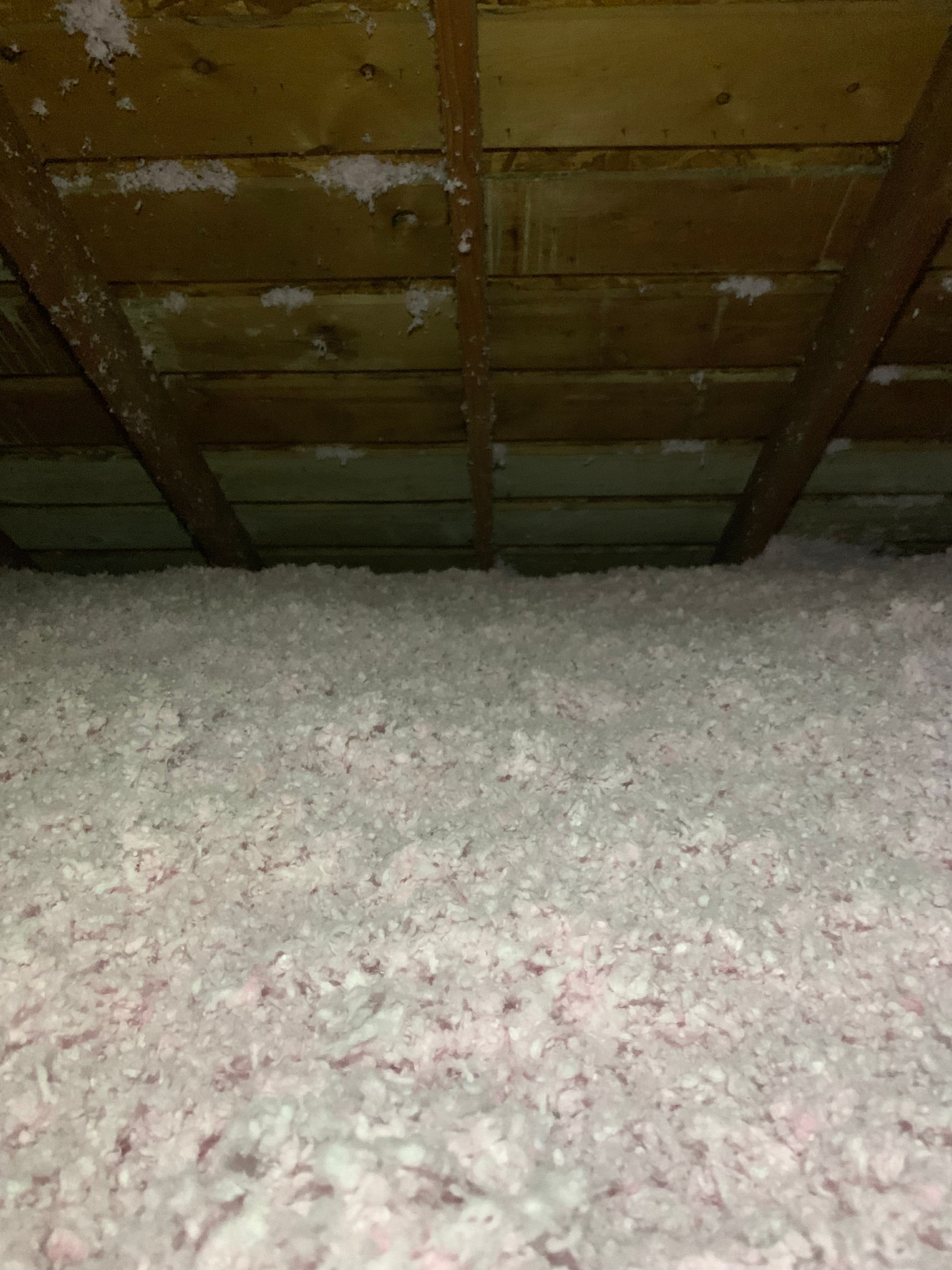 Evenly installed blown-in attic insulation across attic floor