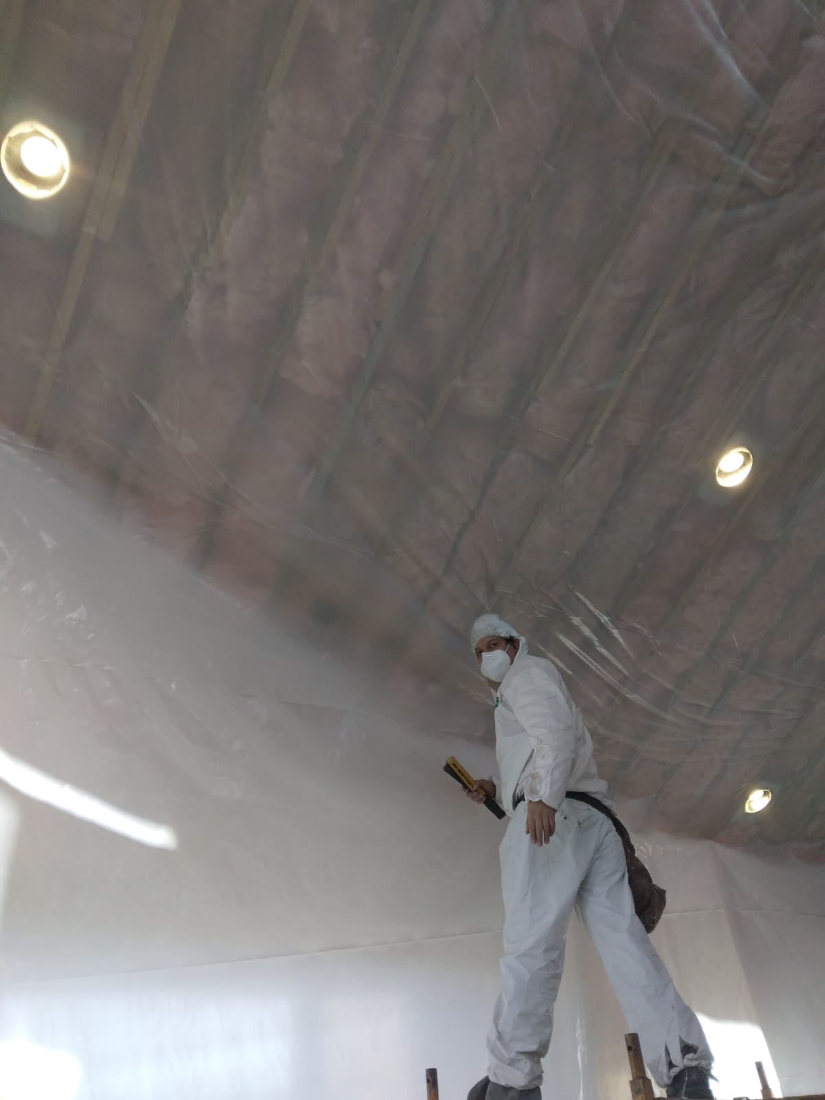 Palencia Insulation team member working in an attic