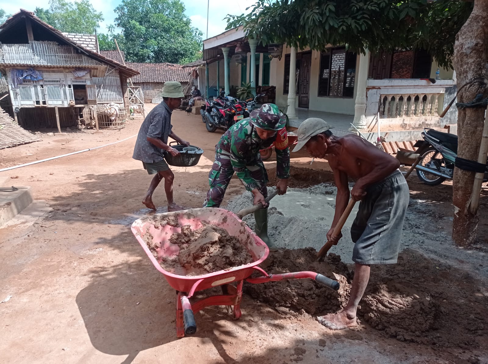 Babinsa Koramil 0827/08 Ganding  Bantu Meracik Semen Bangun Rumah Warga Desa Gadu Barat
