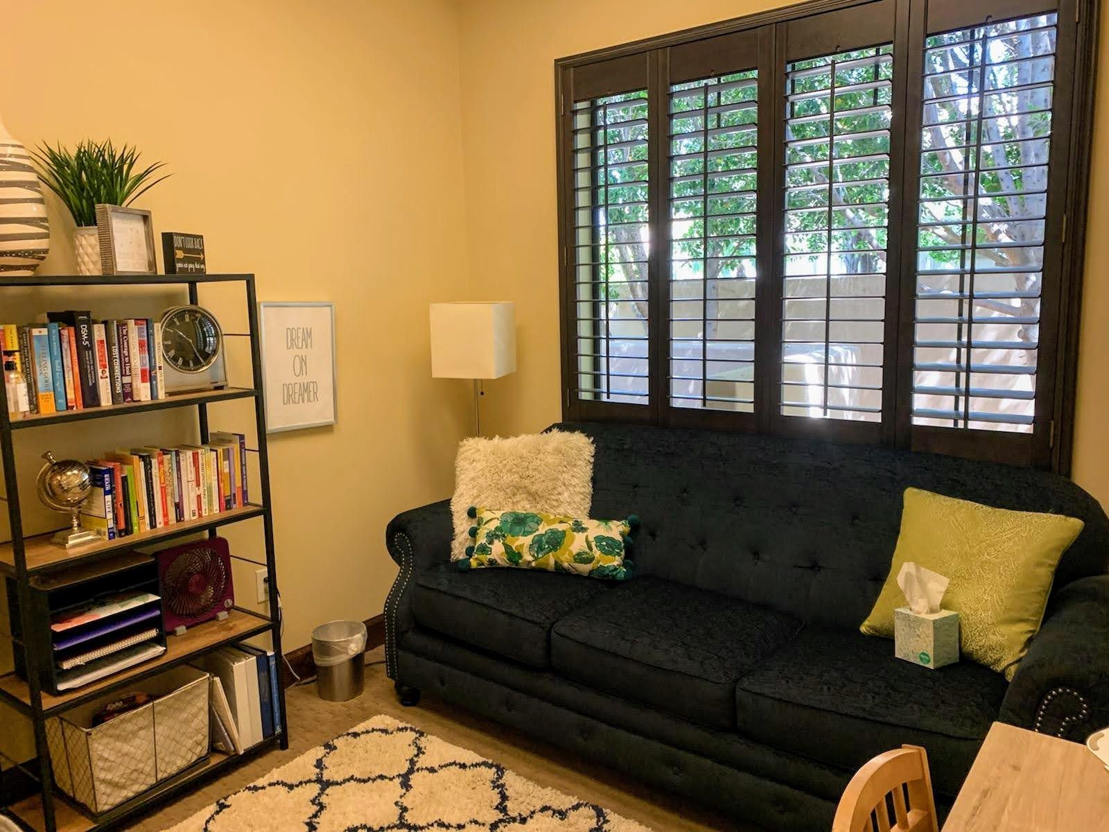Private therapy room with cozy couch and natural lighting