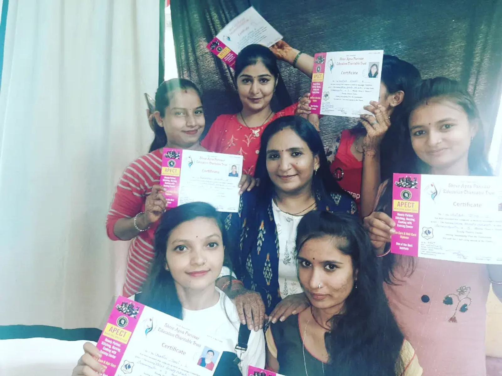 Rajeshree Nanda with a group of women she trained, each holding her beauty-parlour course certificate