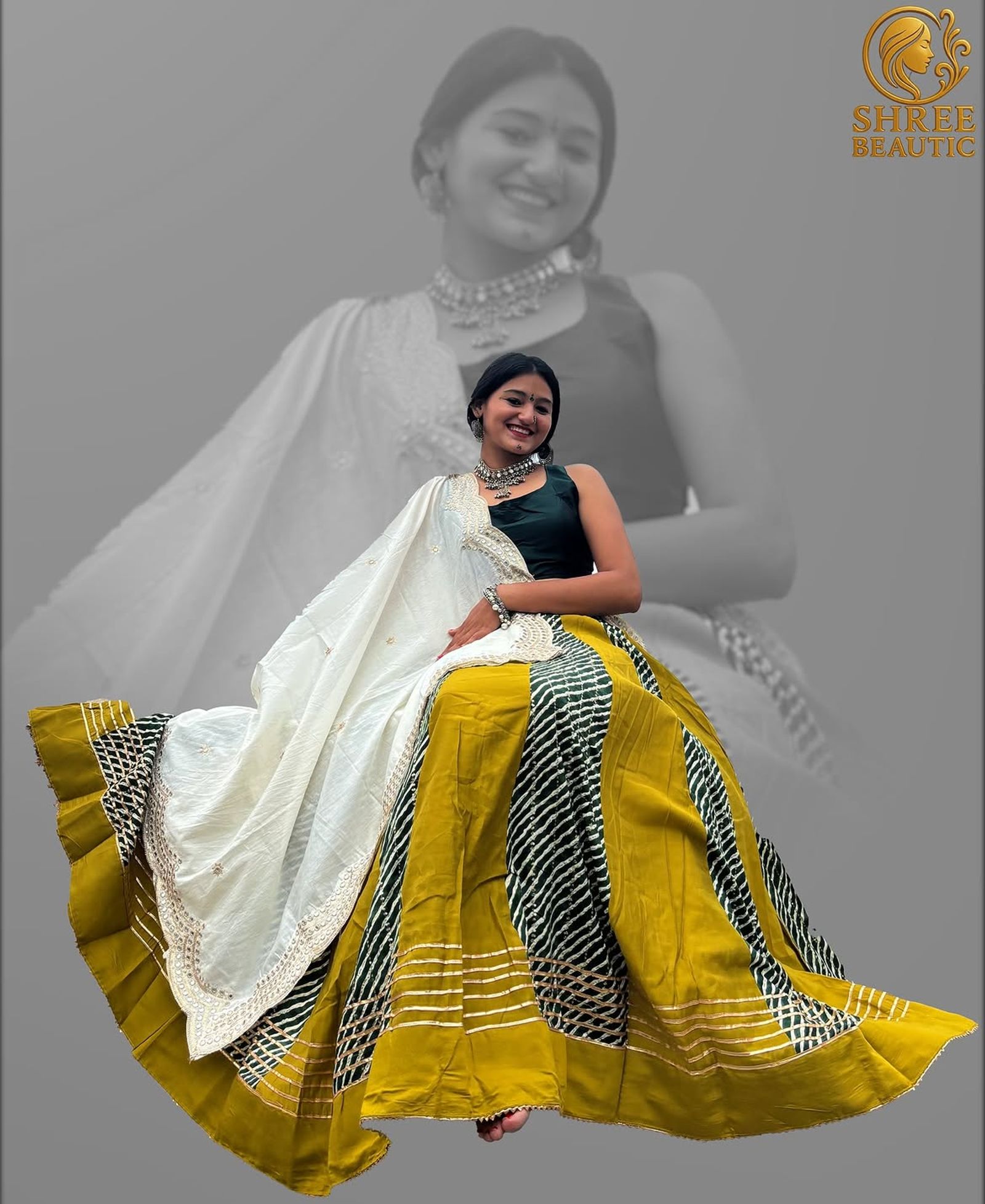 Model seated in a mustard-yellow chaniya choli with dark green leheriya panels and an ivory embroidered dupatta