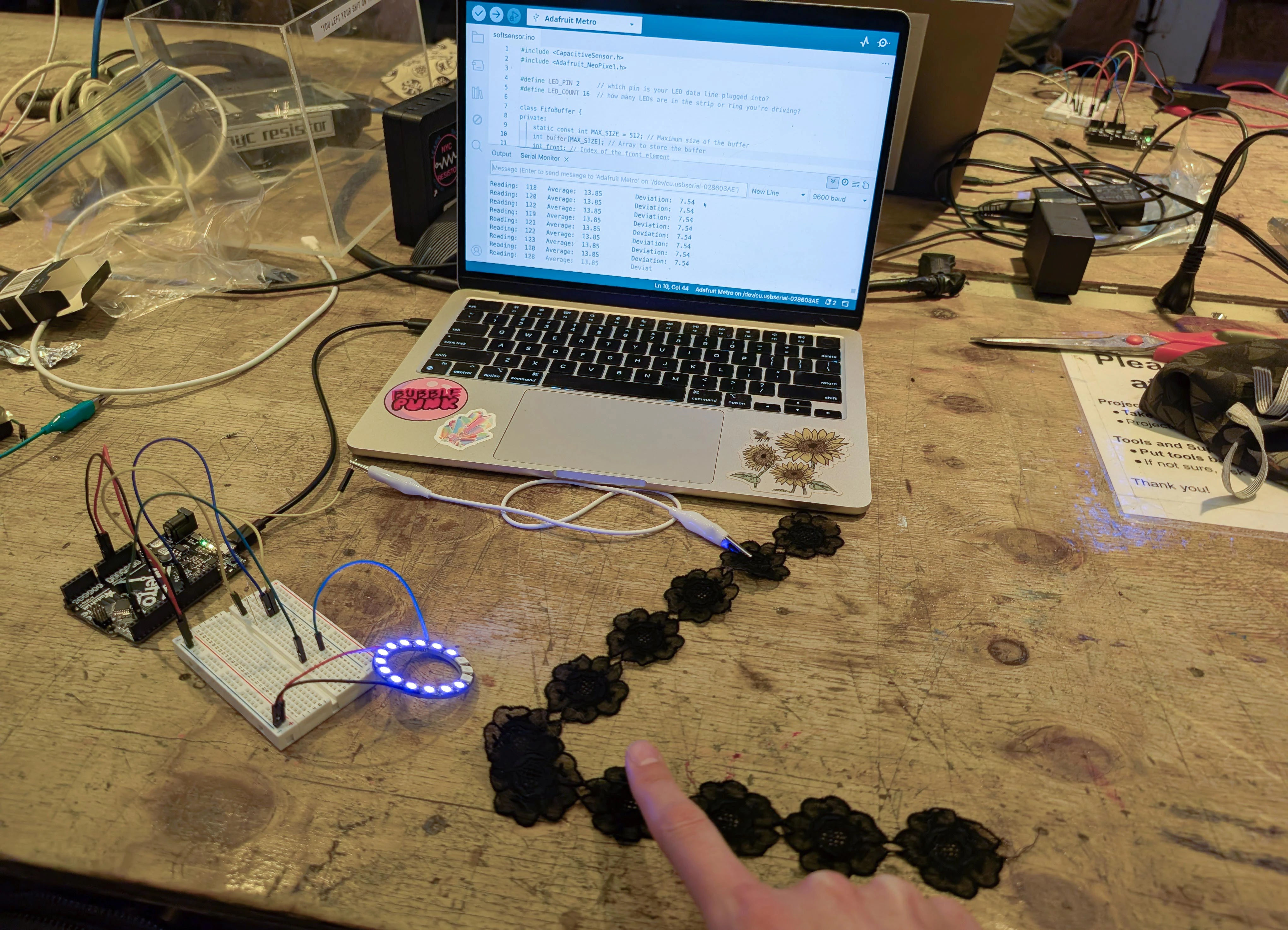 Mandy touching a piece of lace to make some neopixels light up