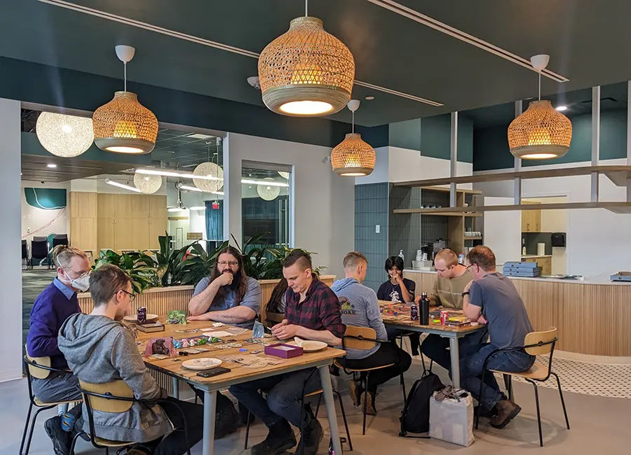 A group of people playing board games in a fancy office
