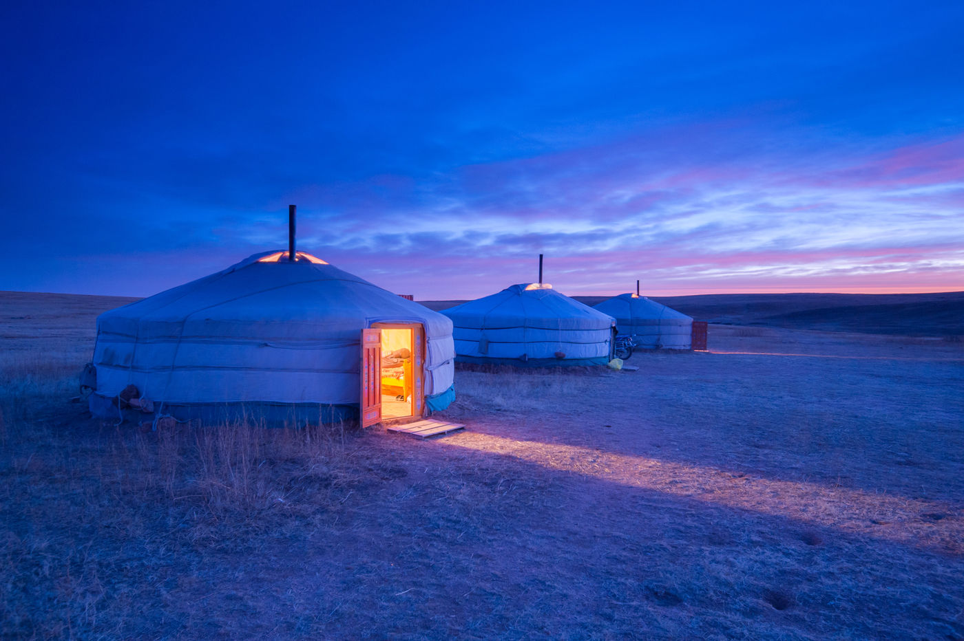 The yurts, combined with the hour of blue light, produce a magical scenery.  © Billy Herman