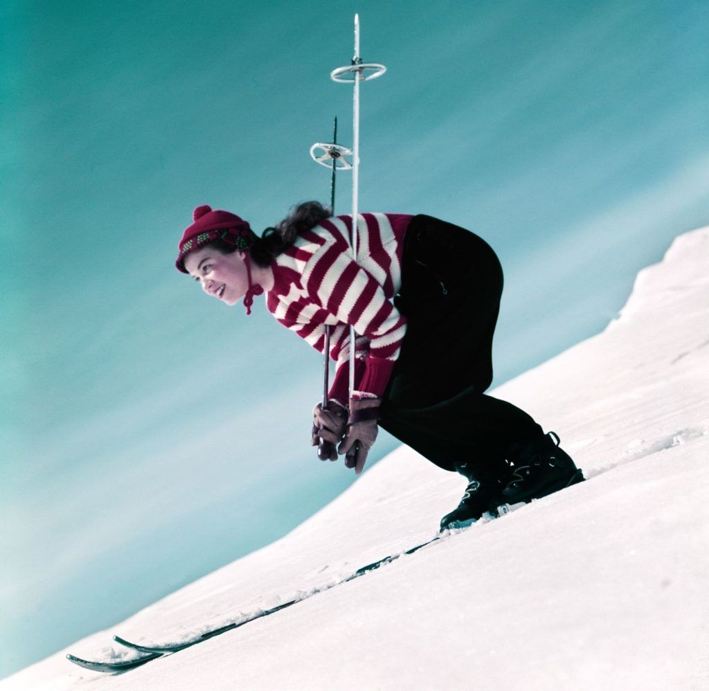A girl skiing in the 1950s wearing a Waldo inspired funny skiing outfit.