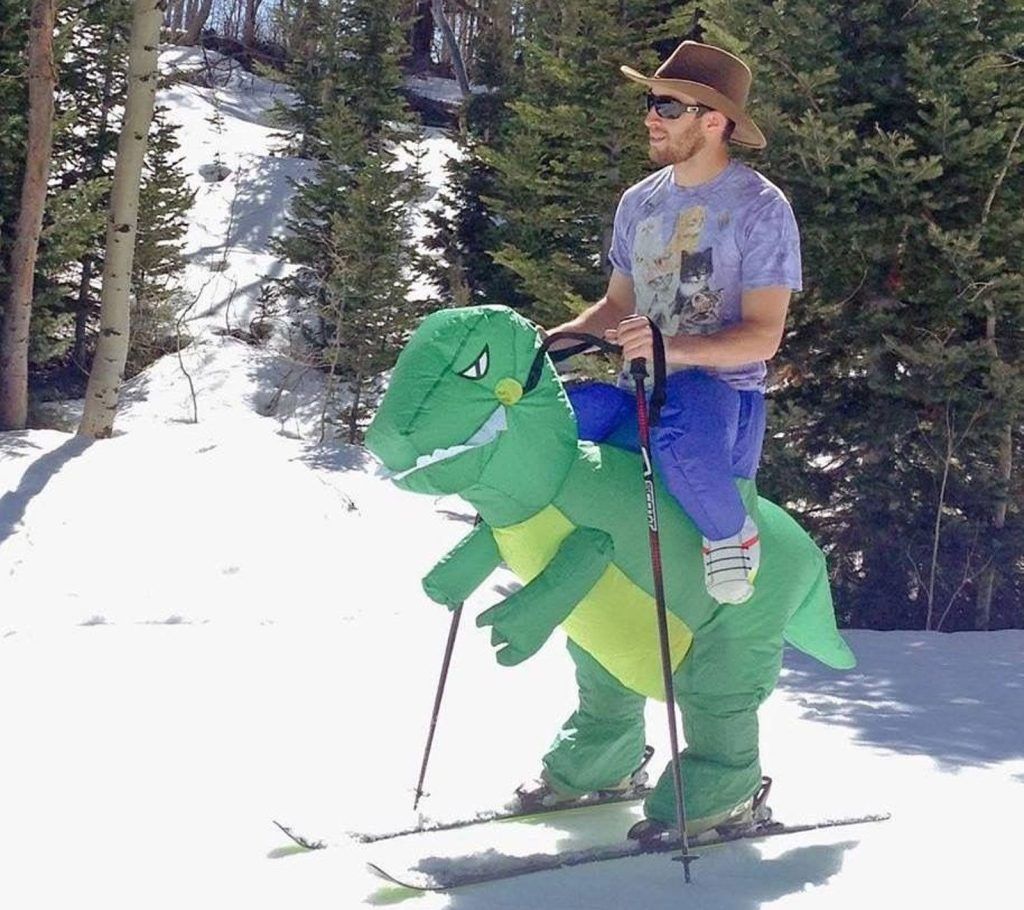 Among all funny skiing outfits an inflatable dinosaur one wins.