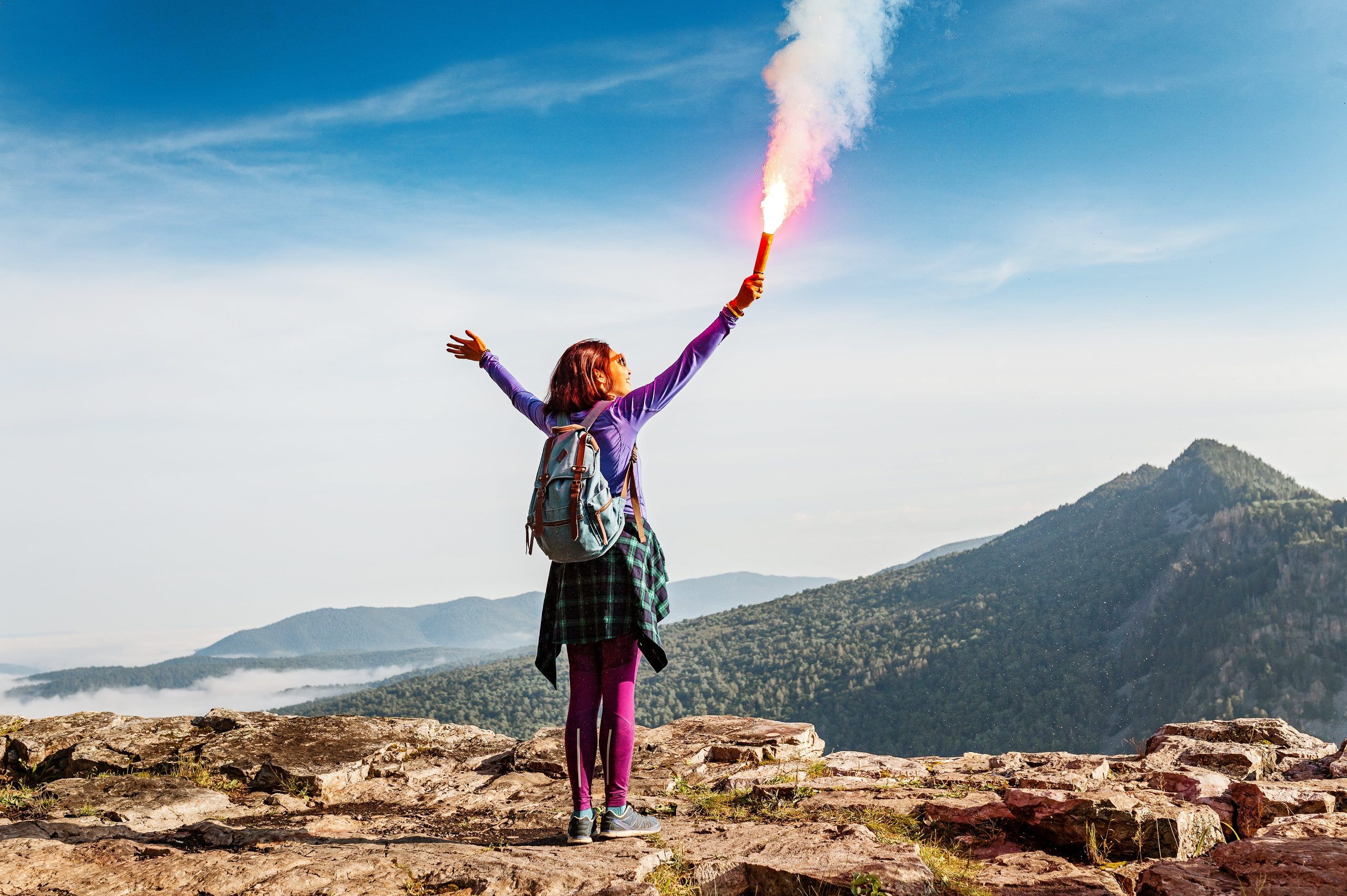 A girl in the mountains properly signalling being lost or injured