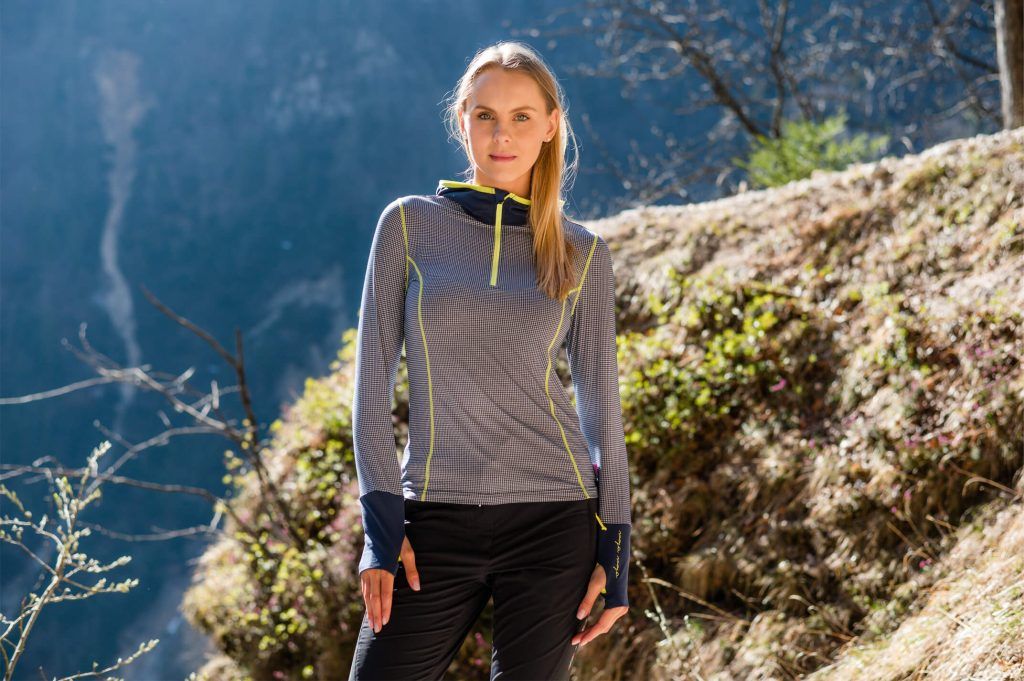 A woman wearing a lightweight and highly breathable women’s trekking hoodie.