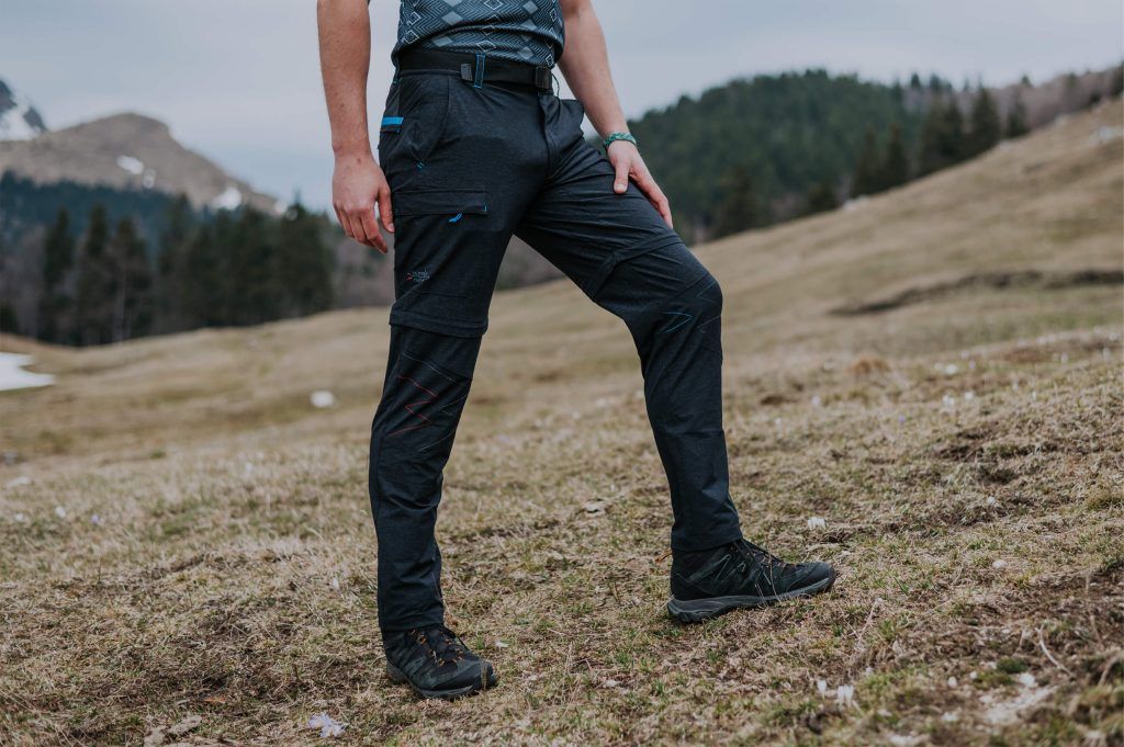 A man wearing hiking and trekking pants on a mountain.
