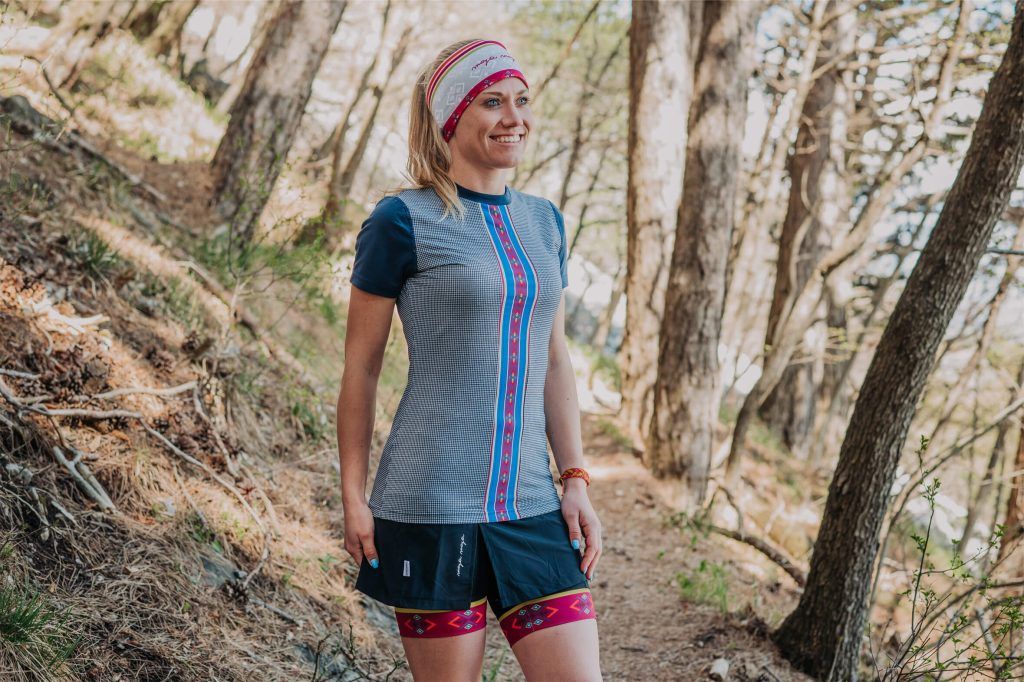 A woman in the forest wearing a lightweight and breathable women’s running and trekking T-shirt.