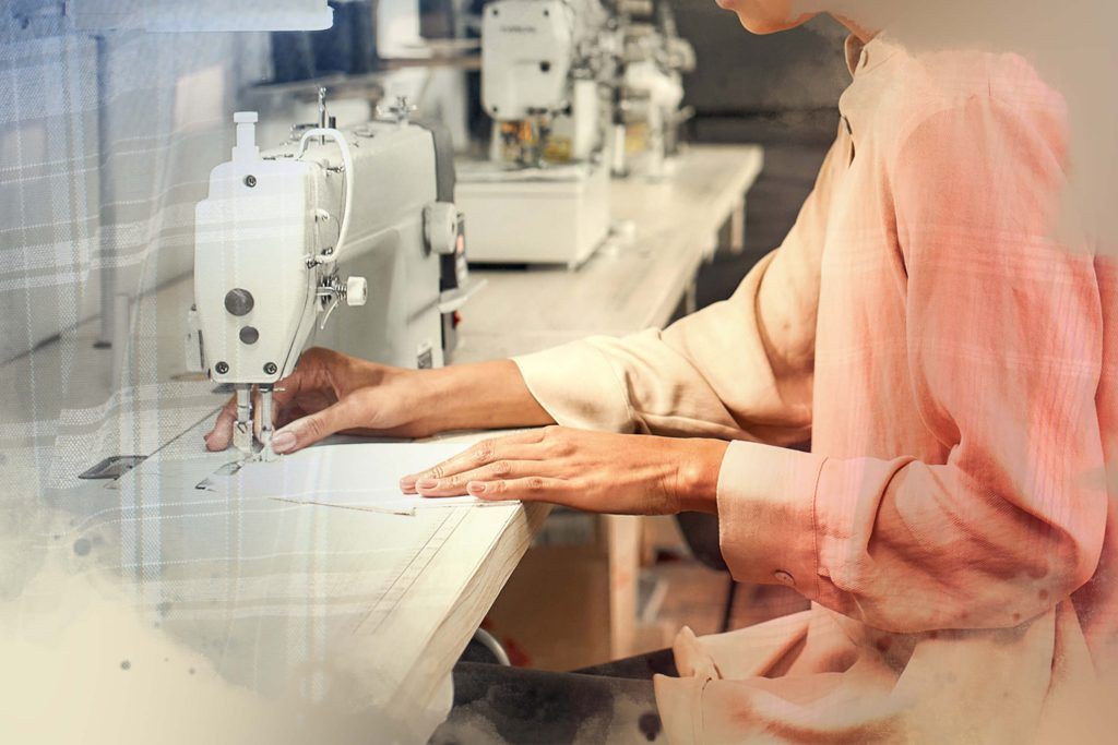 Women fixing clothing with her sewing machine while sitting