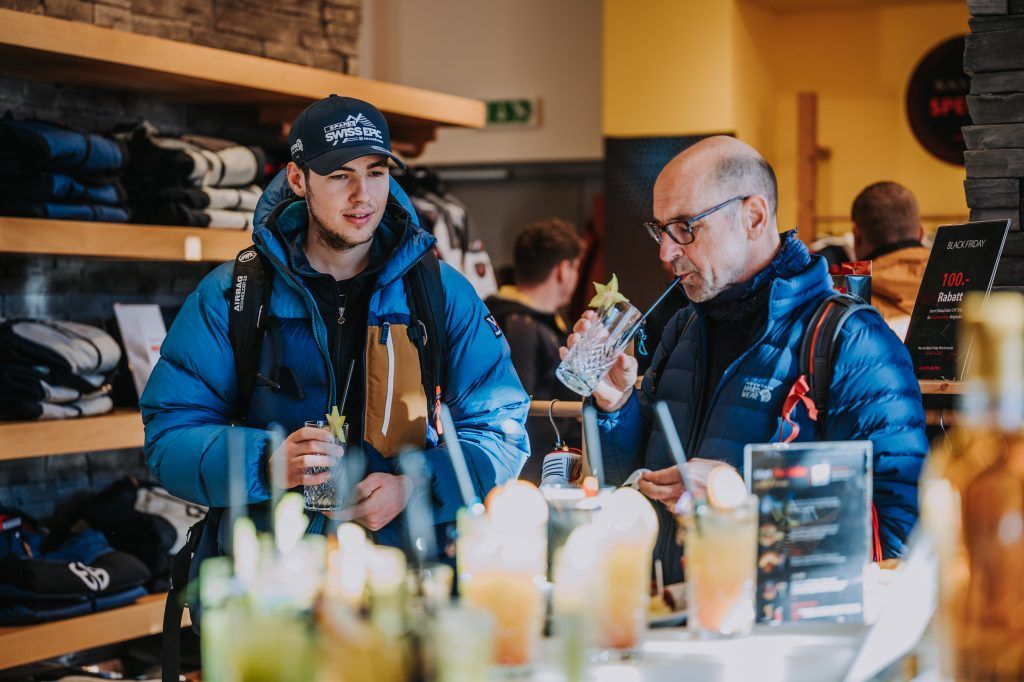 Customers drinking cocktails at an event.