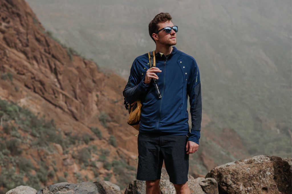 A man in rocky mountains wearing Trail sweater perfect for hiking.