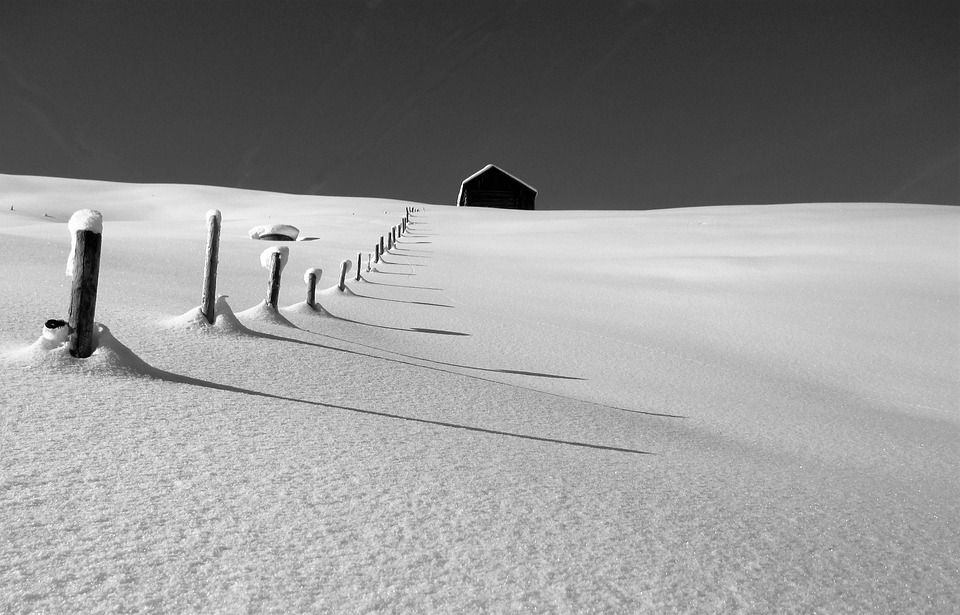 A snowy hill with a hut.