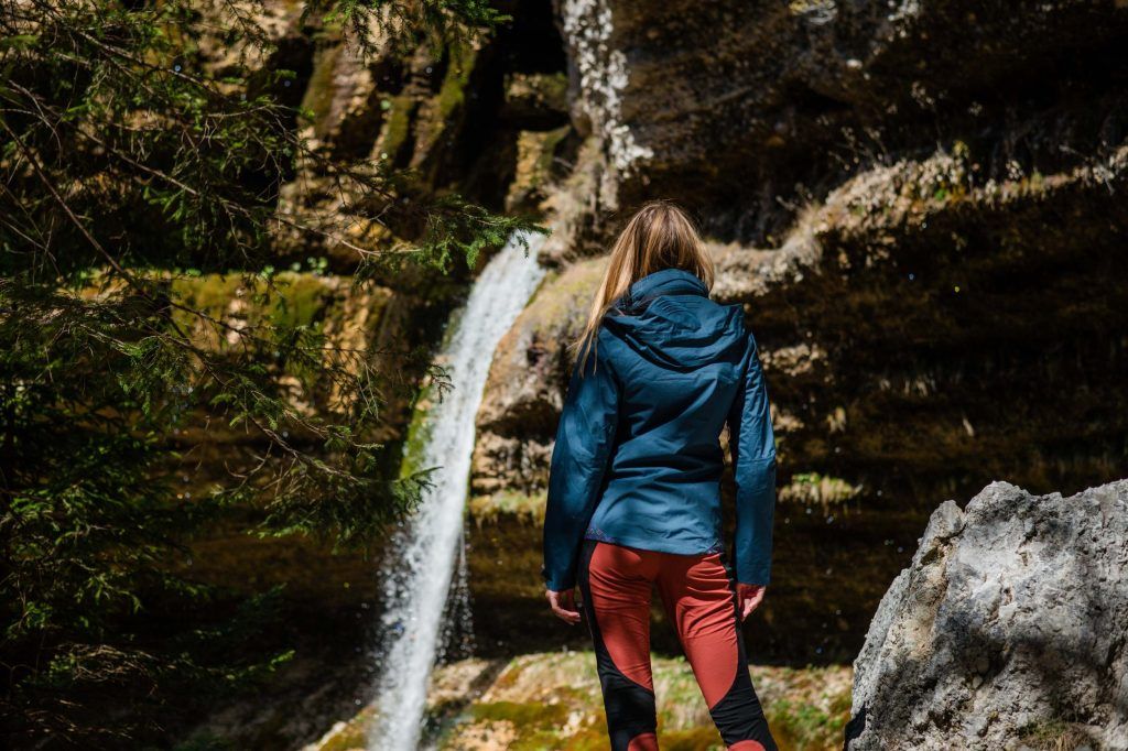 Women standing by the waterfall wearing functional extreme weather clothing from MAYA MAYA