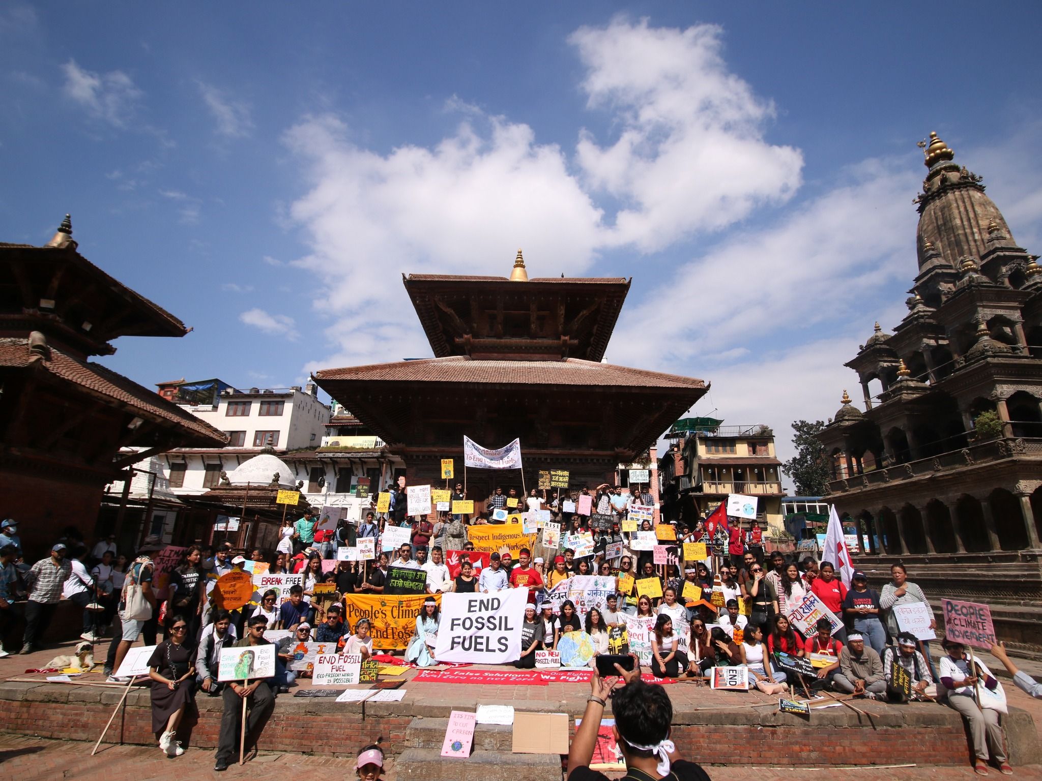 Climate activists with protest signs