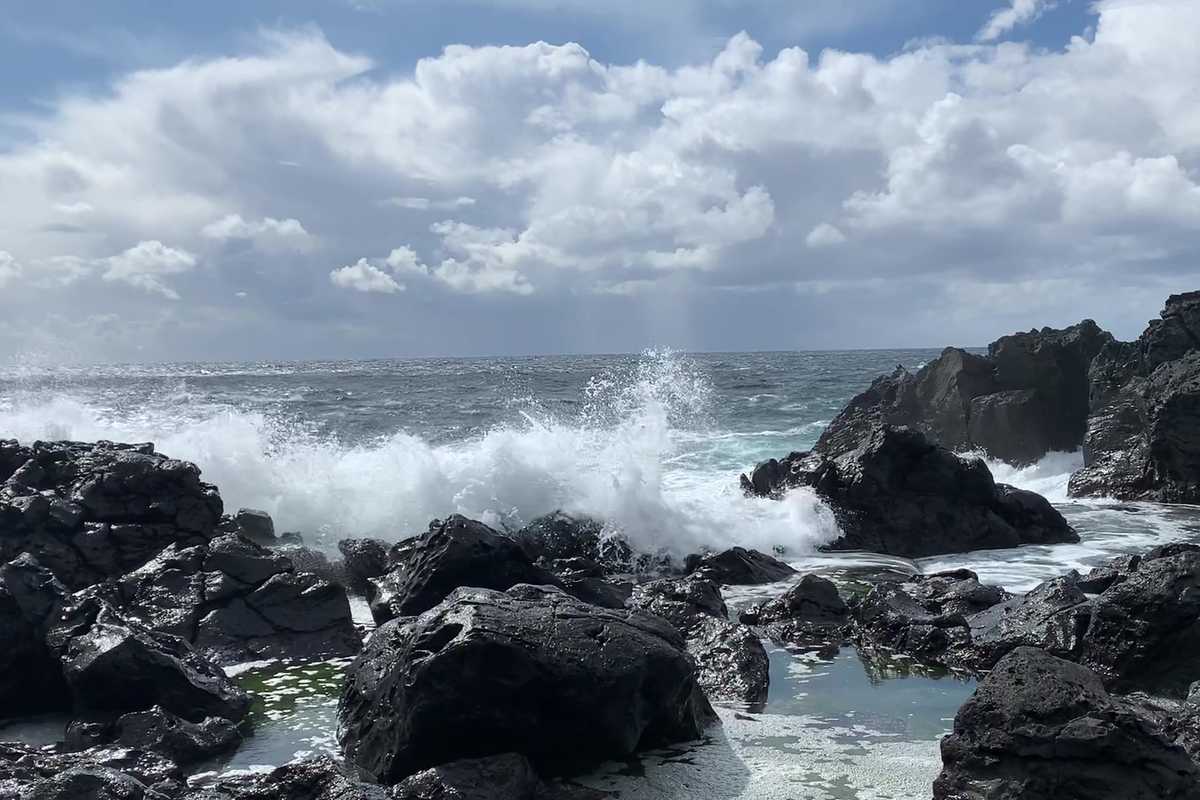  An international team of researchers led by Jian Wang, professor of energy, environmental & chemical engineering, found that strong wave breaking along the shore, particularly during high wave periods, can produce large amounts of sea spray aerosols, significantly increasing both the number of cloud condensation nuclei and the mass of airborne particles in coastal regions. (Credit: Wang lab)