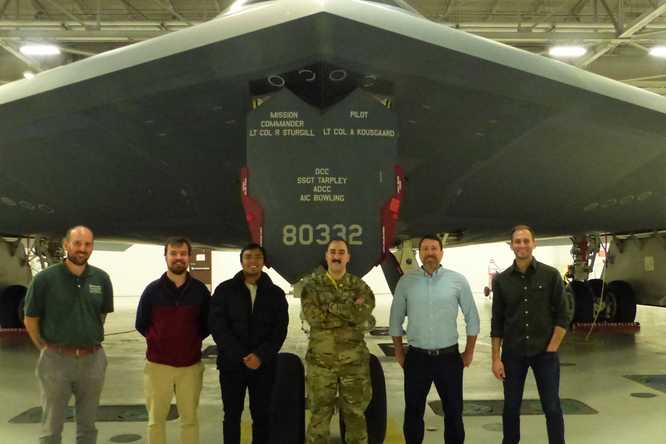 Jon Shidal (far left), lecturer and Capstone instructor, with students from the Innovating for Defense class and airmen on the visit to Whiteman Air Force Base. Courtesy of National Security Innovation Network.