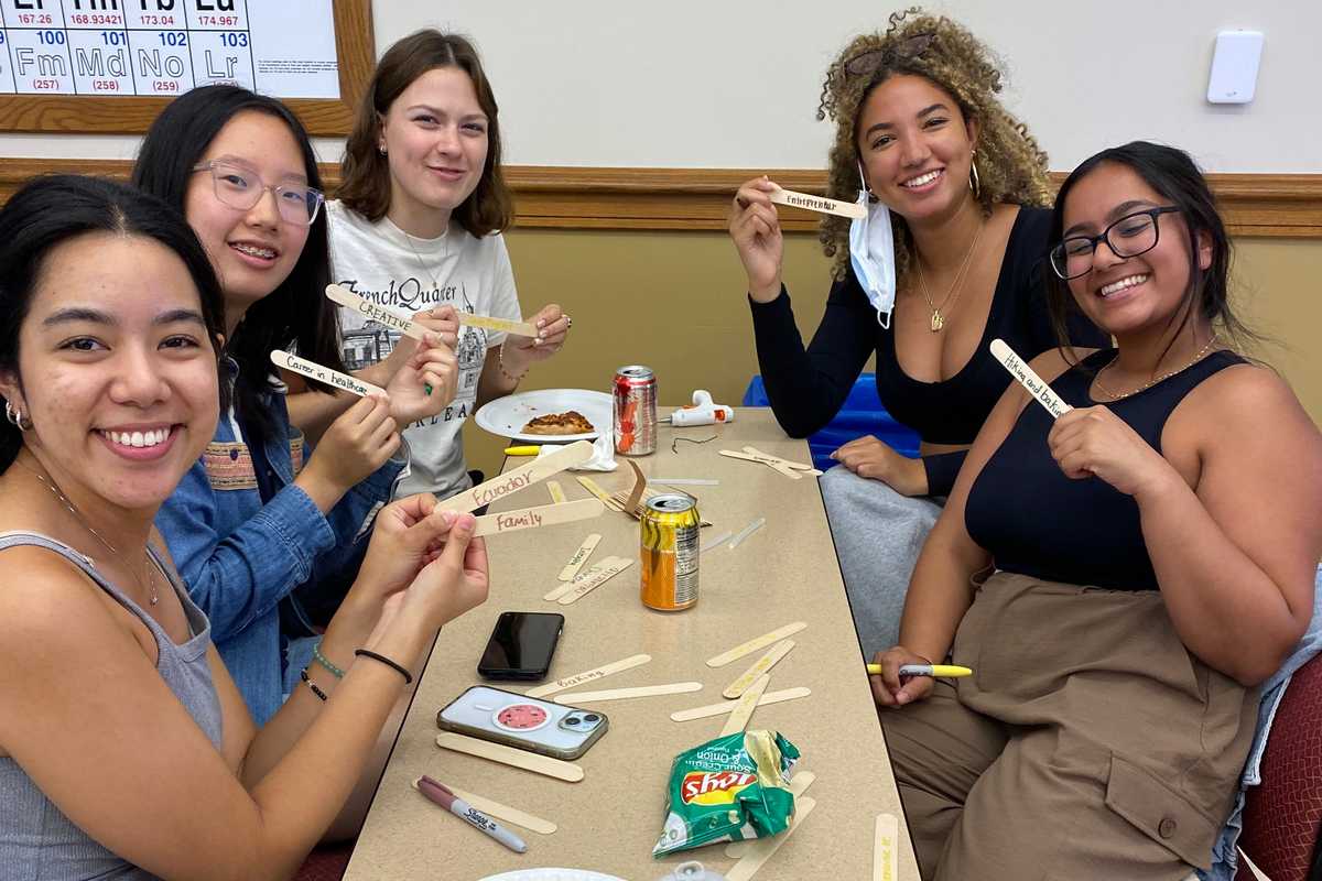 Students attending the first McKelvey Believes meeting of the year wrote aspects of their identities on wooden sticks and worked with a team to build bridges to explore the role of identity in engineering.