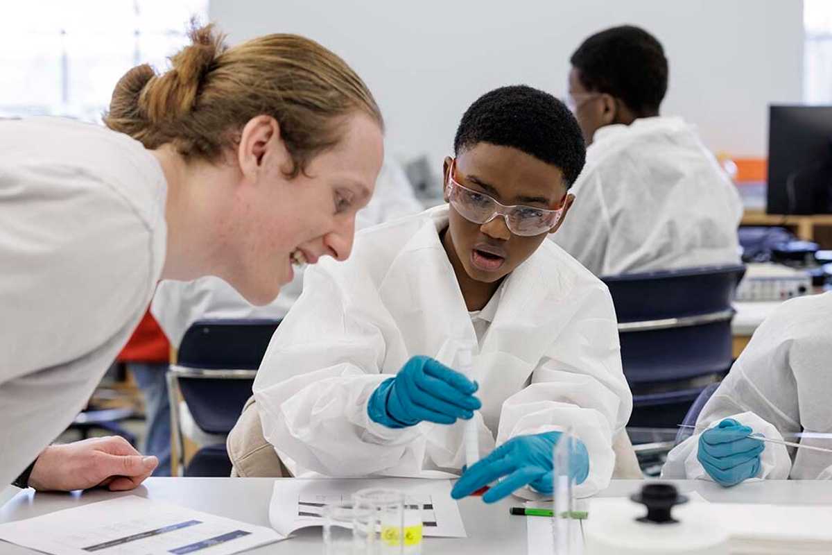 McKelvey Engineering student Hayden Carlson works with students from Central Middle School in the Riverview Gardens School District during the "Researcher for a Day" program. (Photo: Whitney Curtis/WashU)