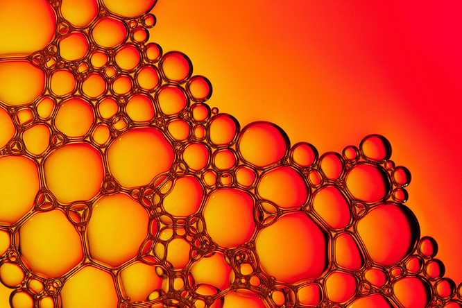 Biomolecular condensates often appear like soap bubbles but are actually more like silly putty, featuring mostly elastic and viscous behaviors on different timescales. WashU researchers have devised a method to image the internal organization within condensates to arrive at a structural explanation for condensate viscoelasticity. (Image: Shutterstock).