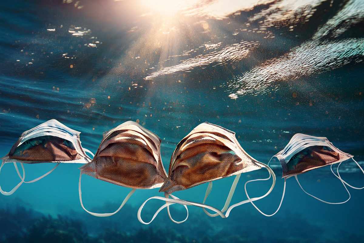The ubiquitous face masks discarded during the COVID-19 pandemic break down into microplastics and face further chemical changes, affecting its transport in aquatic environments. (Image: Generated in Adobe by Young-Shin Jun)  