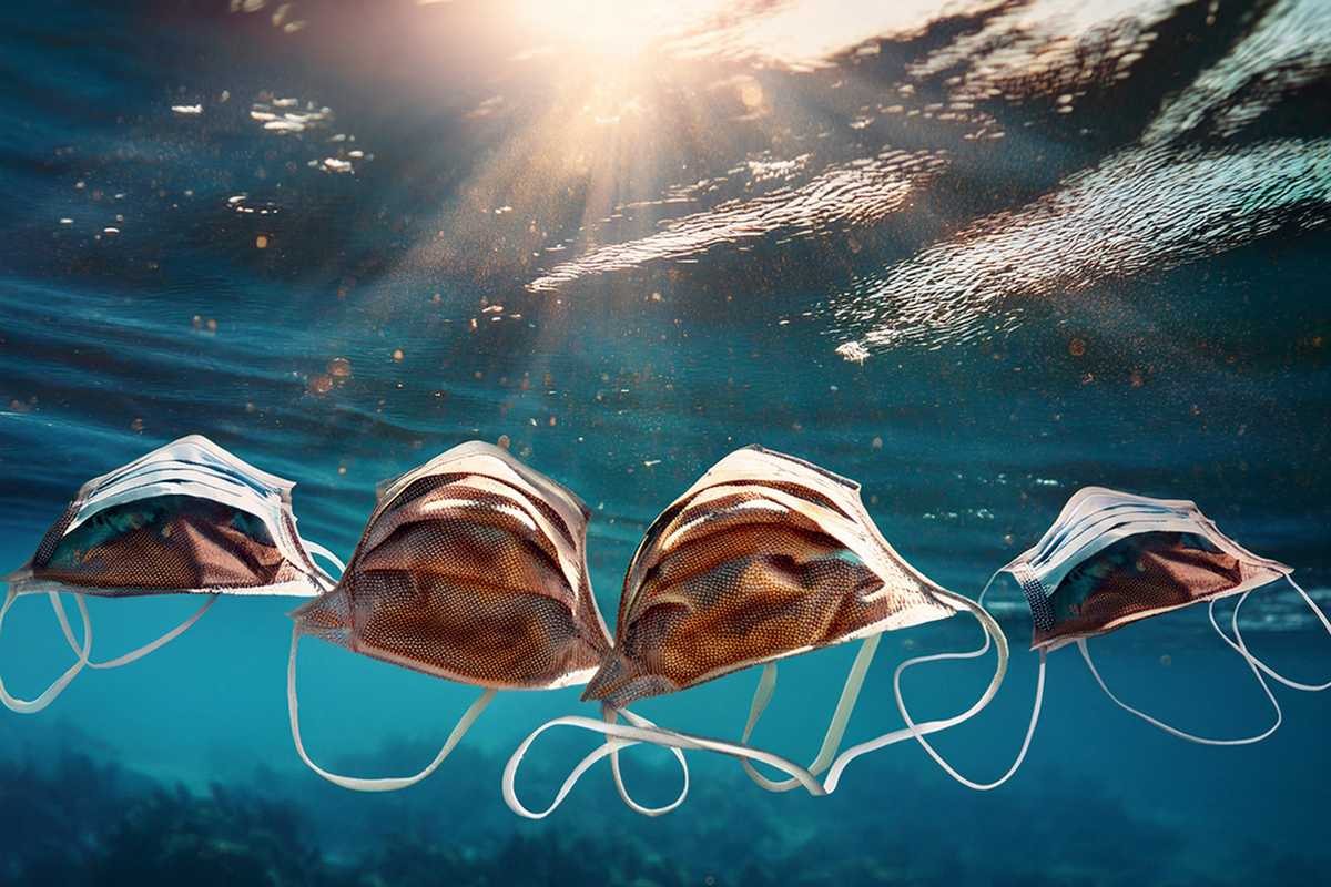 The ubiquitous face masks discarded during the COVID-19 pandemic break down into microplastics and face further chemical changes, affecting its transport in aquatic environments. (Image: Generated in Adobe by Young-Shin Jun)  