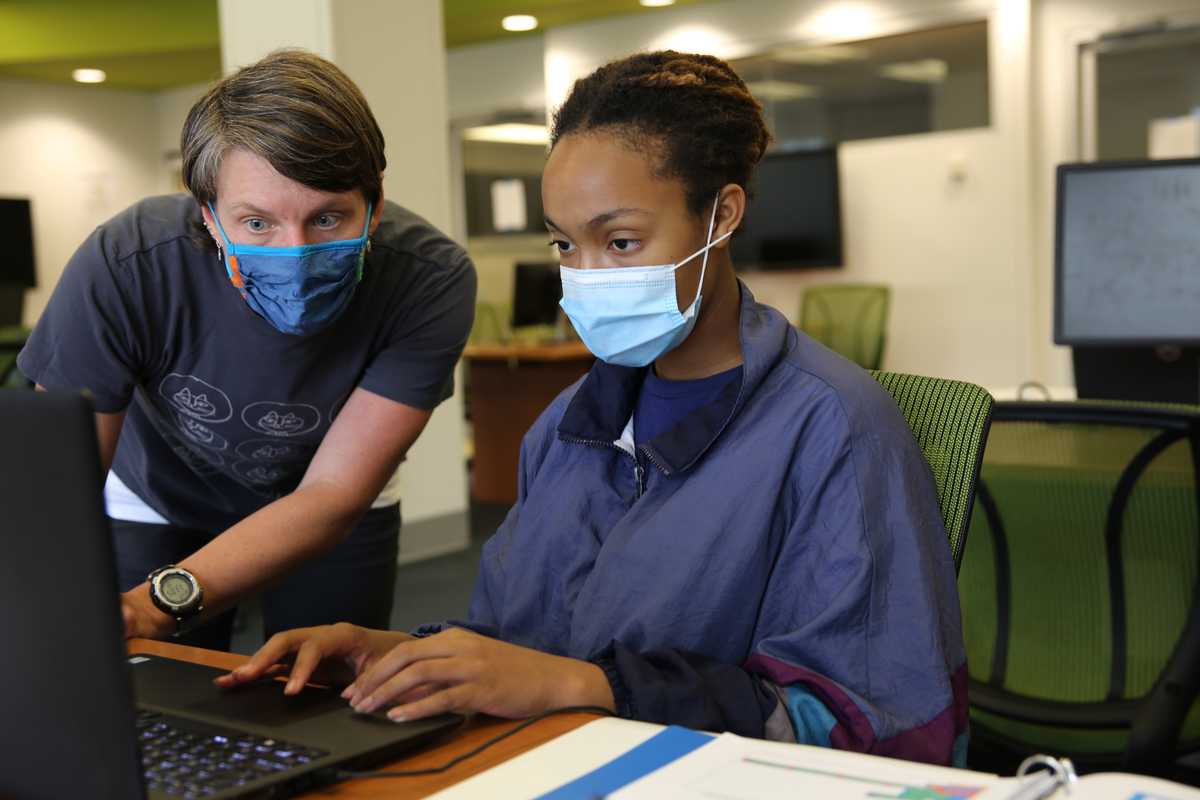 Marion Neumann, left, works with a student during the 2021 AI for St. Louis summer camp. Submitted photo