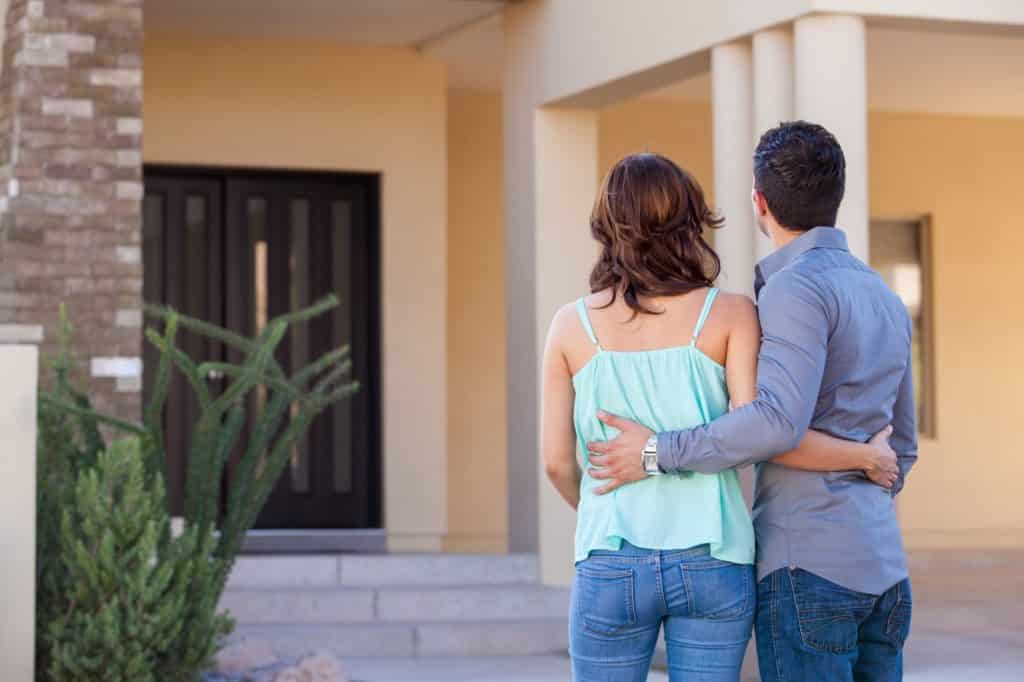 Home remodel tallahassee fl Home buying tips Couple looking at their beautifully remodeled home.